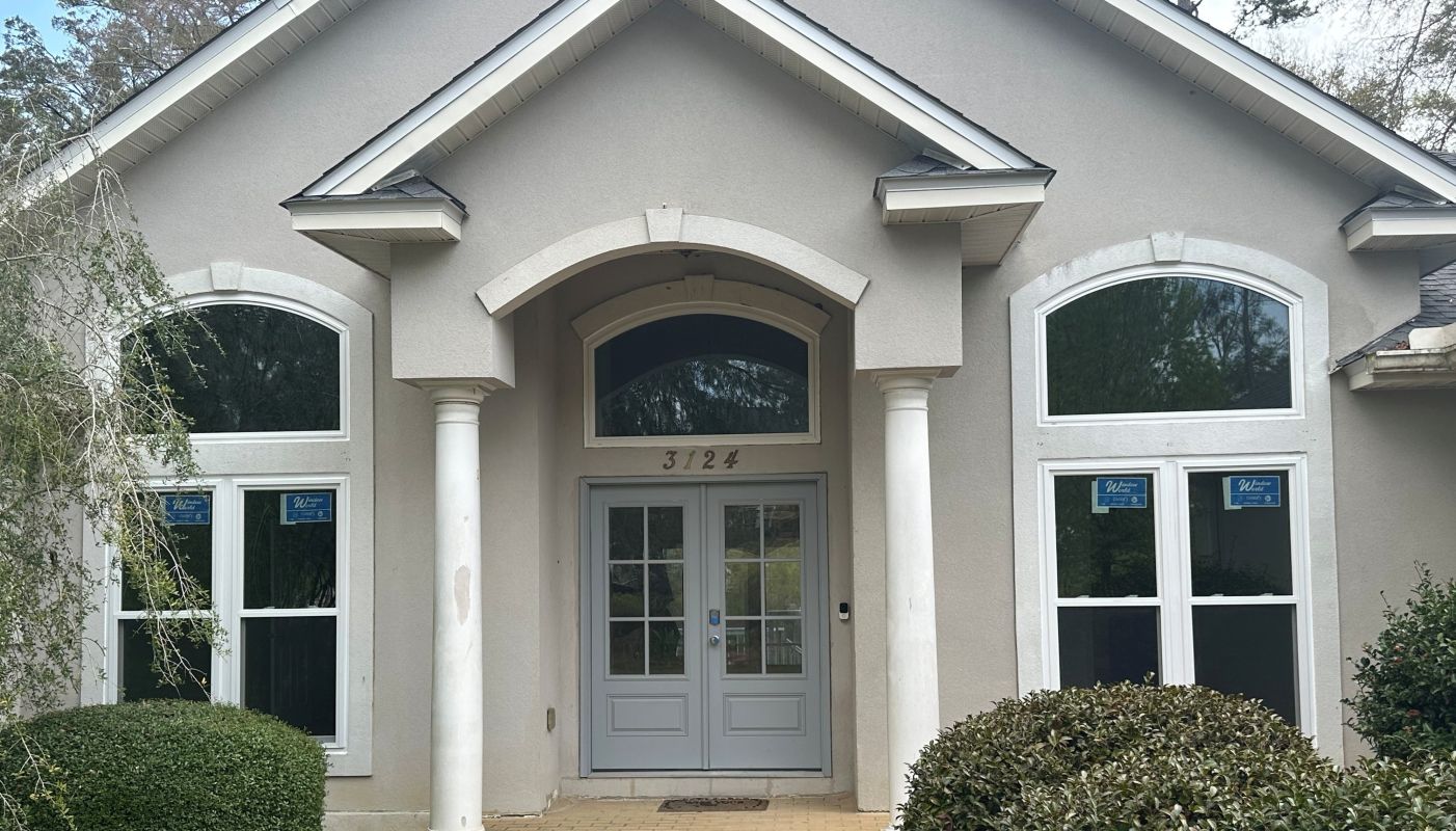 Stucco home with special shape over door and twin units