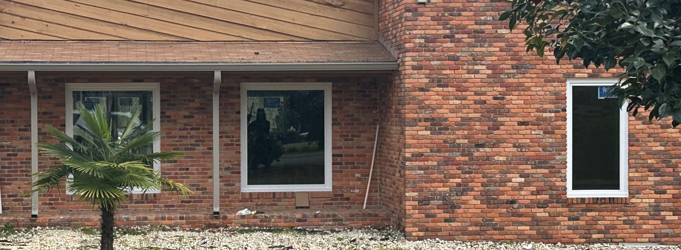 White  picture windows and casement in multi-color brick