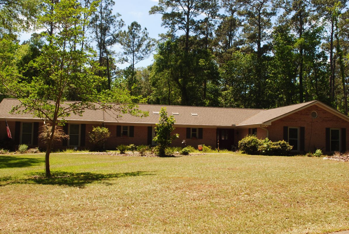 Traditional brick ranch with castle grey windows