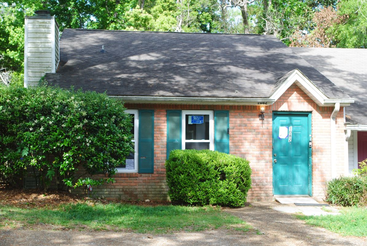 Townhome with white windows and medium brick