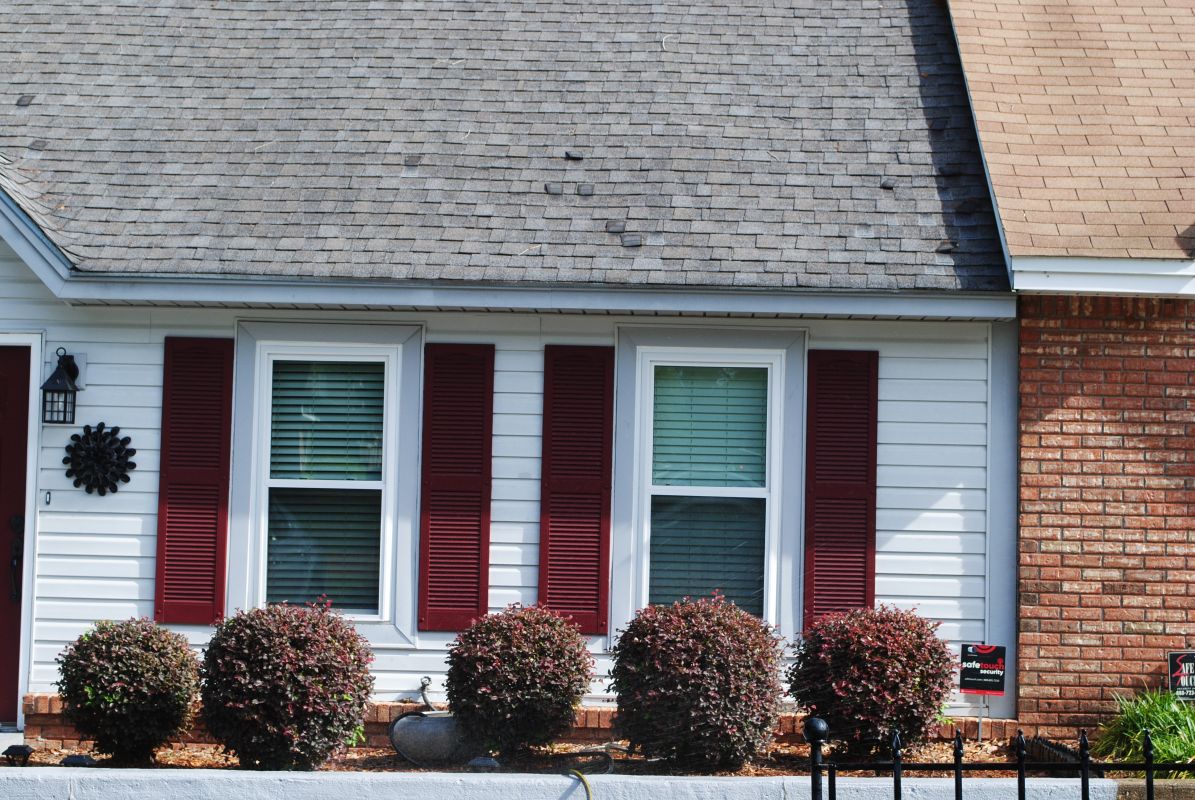 Townhome with white windows and grey siding
