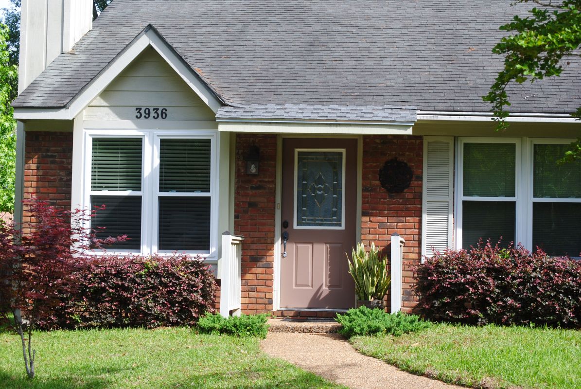 White windows, light grey siding and shutters in dark brick