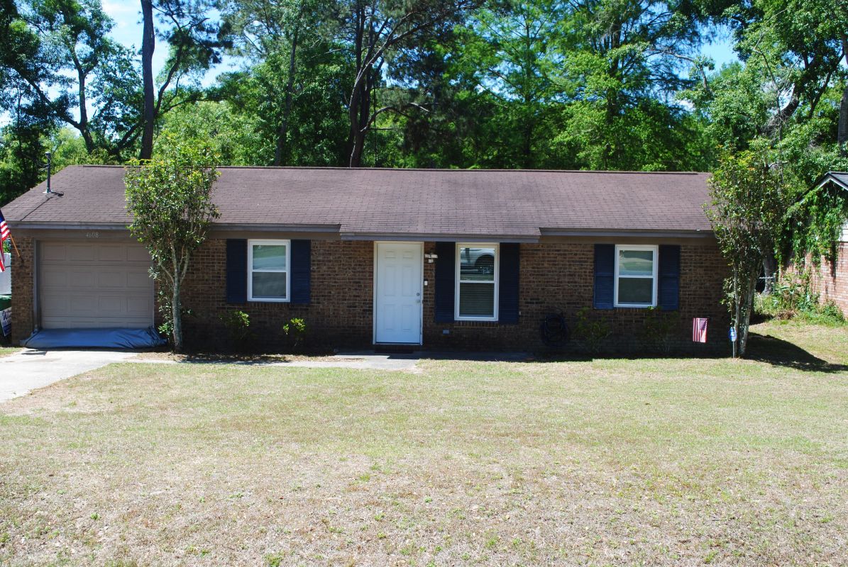White windows in dark brick ranch