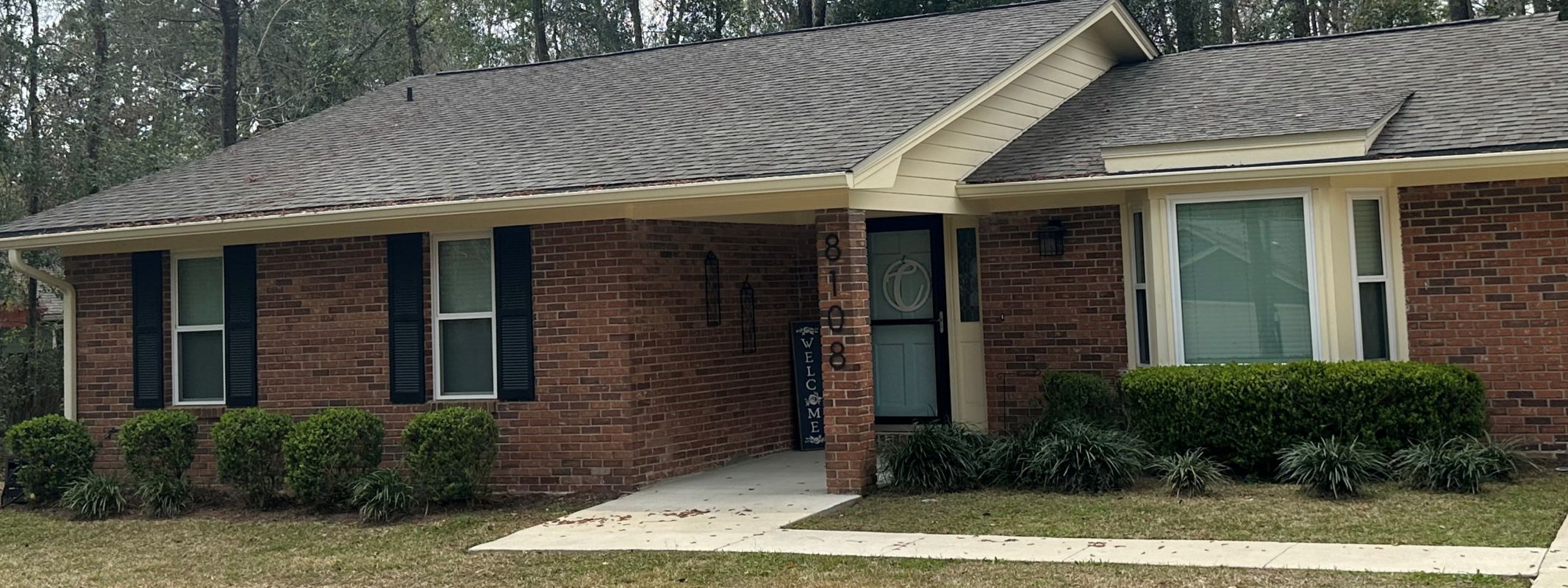 traditional ranch with white windows in medium brown brick