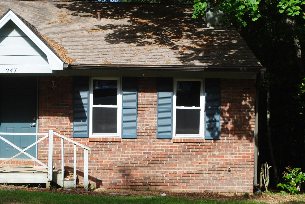 Townhome with white windows and medium brick